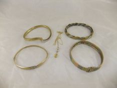 A 9 carat tri-colour gold bracelet, a gold and diamond set bangle, a bi-colour bangle, and a 9 carat