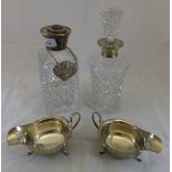 A pair of George V silver sauce boats (London 1932), two silver collared cut glass decanters,