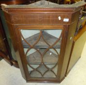 A mahogany wall hanging corner cabinet with astragal glazed doors and inlaid decoration