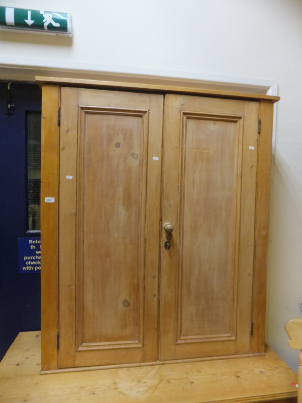 A Victorian pine two-door cupboard