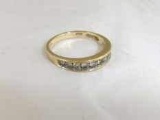 A gold half eternity diamond ring