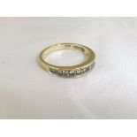 A gold half eternity diamond ring