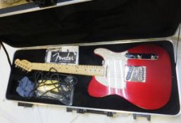 A Fender American Standard Telecaster Candy Cola electric guitar with pearl scratch plate,