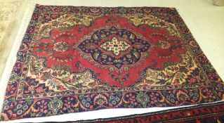 A European Persian design rug, the central medallion in cream, blue and red,
