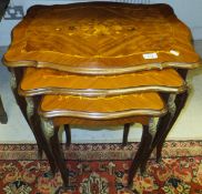 A 20th Century walnut and inlaid nest of three occasional tables in the Louis XV taste
