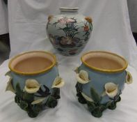 A pair of majolica jardiniers, leaf decorated with lilies and swallows,