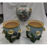 A pair of majolica jardiniers, leaf decorated with lilies and swallows,