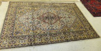 A Persian design rug with central medallion on a cream ground,