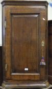 An 18th Century oak corner cupboard,