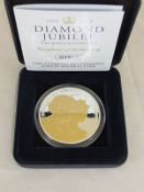 A Guernsey Queen Elizabeth II Diamond Jubilee silver £5 coin with selective gold ink on obverse