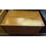 A stained pine blanket box / coffer to plinth base and castors