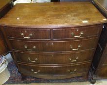 A Regency style mahogany bow fronted chest of two short and three long drawers on spade feet