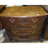 A Regency style mahogany bow fronted chest of two short and three long drawers on spade feet
