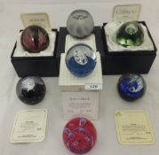 A collection of seven Caithness glass paperweights - one inscribed "To celebrate the 40th