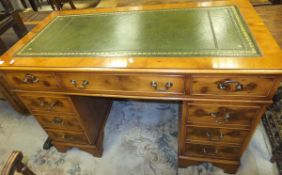 A reproduction mahogany yew wood kneehole desk,