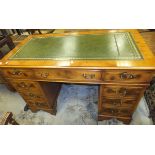 A reproduction mahogany yew wood kneehole desk,