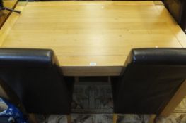 A modern oak rectangular dining table and four brown leatherette dining chairs