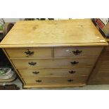 A Victorian pine chest of two short and three long drawers with shaped apron and turned front legs