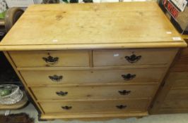 A Victorian pine chest of two short and three long drawers with shaped apron and turned front legs