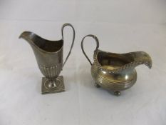 A late Victorian silver helmet shaped cream jug on square base (London 1897),