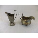 A late Victorian silver helmet shaped cream jug on square base (London 1897),