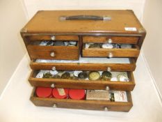 An engineer's tool box containing various pocket watch spares, to include enamel dials,