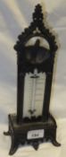 A Victorian patinated bronze pocket watch stand / barometer with Gothic arch and pilaster