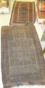 A Beluche tribal prayer rug with repeating medallion decoration on a madder ground within a