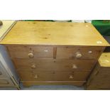 A pine chest of two short and two long drawers with turned wooden handles,
