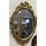 A gilt framed oval wall mirror with bevel edged plate CONDITION REPORTS Please not that this appears
