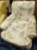 A late Victorian upholstered scroll armchair (in the Howard manner),