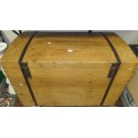 A large pine dome top trunk with wrought iron fitments and handles