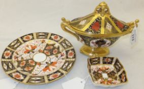 Three pieces of Royal Crown Derby to include an oval sucrier and cover, a plate and a trinket dish