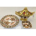 Three pieces of Royal Crown Derby to include an oval sucrier and cover, a plate and a trinket dish