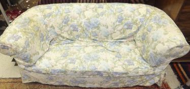 A circa 1900 Chesterfield settee with floral loose covers