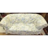 A circa 1900 Chesterfield settee with floral loose covers