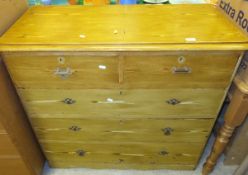 A stained pine chest of two short and three long drawers