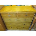 A stained pine chest of two short and three long drawers