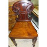 An early 19th Century mahogany panel seated hall chair with C-scroll and cornucopia carved back,