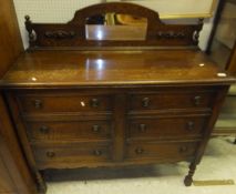 An early 20th Century oak sideboard of six short drawers,