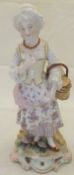 A Dresden porcelain figure of a girl carrying a basket,