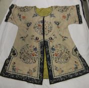 A 19th Century embroidered silk Chinese jacket decorated with various floral sprays