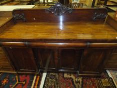 A Victorian mahogany sideboard with raised back over a plain top,