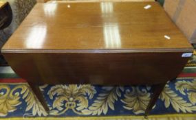 An early 19th Century mahogany drop leaf Pembroke table on square tapered legs to brass caps and