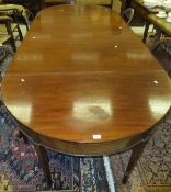 A circa 1900 mahogany D-end dining table with central drop-leaf section, raised on square tapered