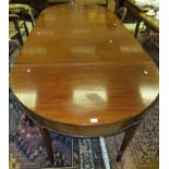 A circa 1900 mahogany D-end dining table with central drop-leaf section, raised on square tapered