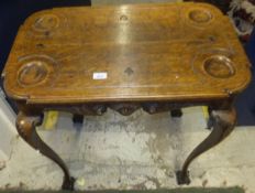A Victorian oak card table, the rectangular top with counter dished corners and trumps carvings,