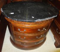 A pair of Universal Furniture commodes of oval form in the George III taste, the black marble top