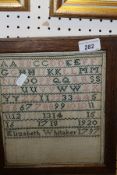 A needlework sampler by Elizabeth Whitaker dated 1797 depicting upper case alphabet,