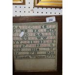 A needlework sampler by Elizabeth Whitaker dated 1797 depicting upper case alphabet,